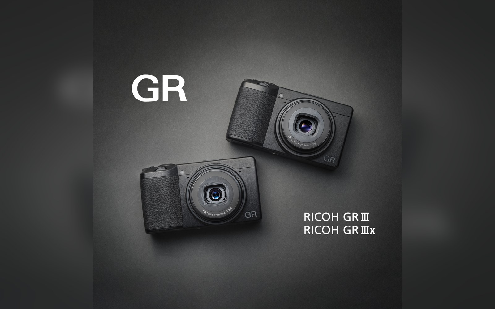 Two black Ricoh GR III compact cameras shown side by side on a dark background
